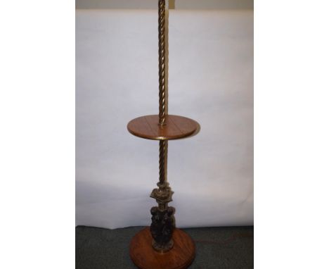 A brass and oak standard lamp, classical figures to base