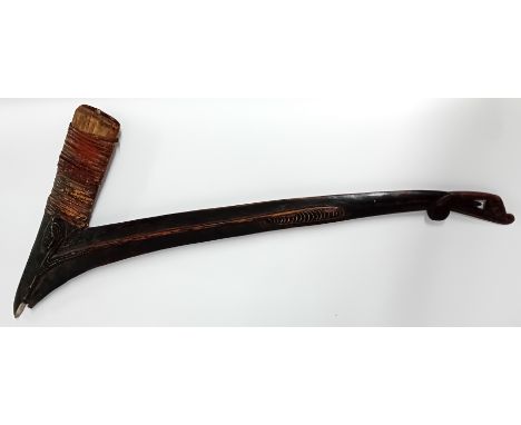An Oceanic ceremonial axe haft, from Massim region of Southern Papua New Guinea, of carved wood and rattan, stone missing, lo