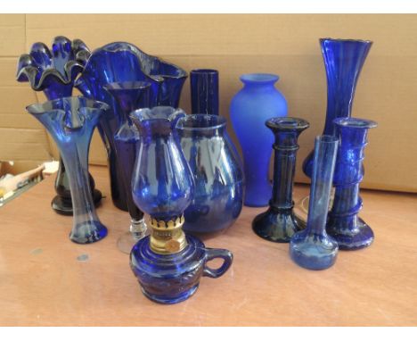 A selection of blue glass including lamp, candlesticks and vase
