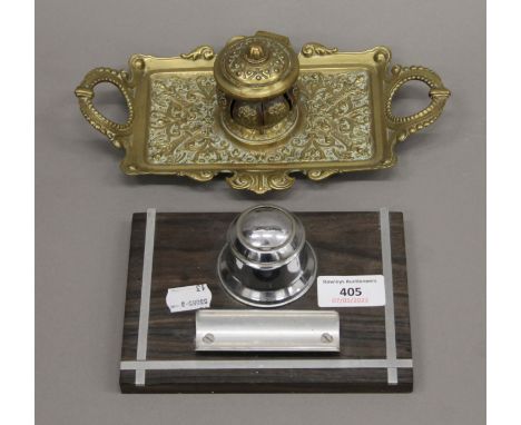A brass inkwell and another inkwell. The former 23 cm wide.