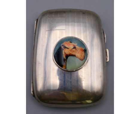 A silver cigarette case centred with dog's head portrait.  8 cm x 6 cm. 
