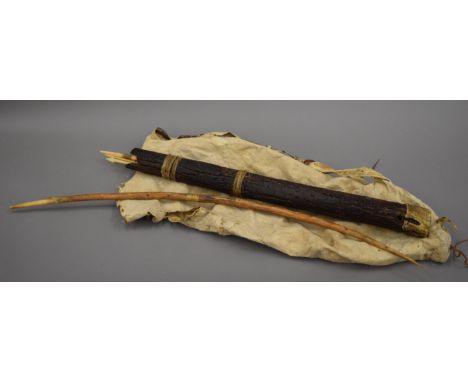 A bow and bone tipped arrows, arrow carrier and wallaby skin water carrier.