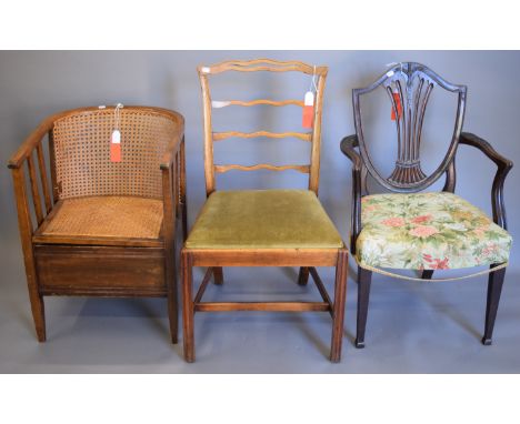 A wavy ladder back chair upholstered with green velvet, a green and red patterned upholstered open arm chair and a wicker sea