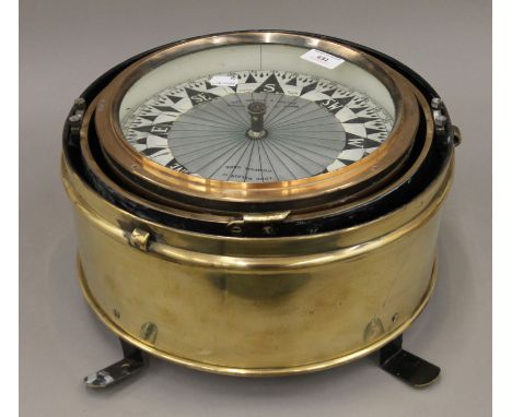 A large brass binnacle compass by Kelvin Hughes Ltd. 34 cm diameter.