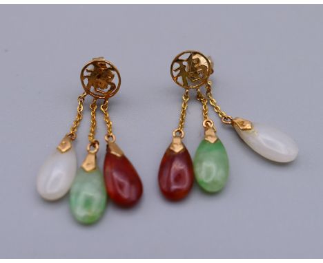A pair of 14 K gold mounted jade drop earrings.  3 cm high.