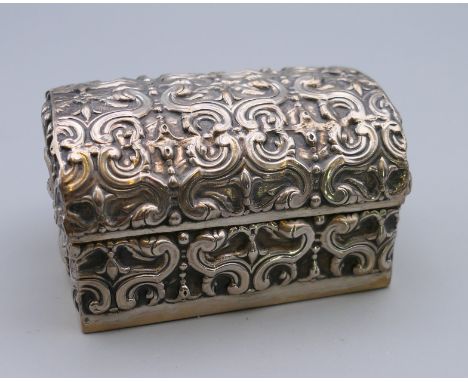 A Continental silver domed casket form box.  6 cm wide, 4 cm high, 4 cm deep. 55.6 grammes total weight.