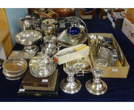 A large collection of silver plated wares including biscuit barrel, candle sticks, spill vases, table wares, cigarette box, a