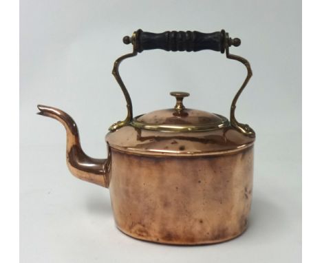 An early Victorian copper kettle with brass mounts and turned wood finial, height 22cm