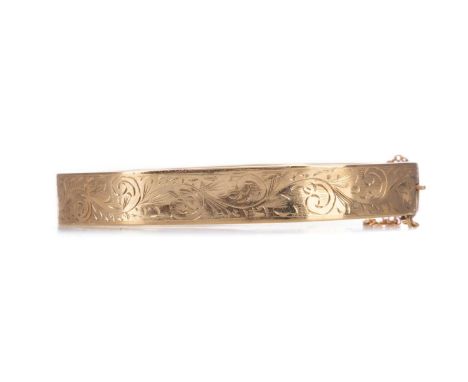 GOLD BANGLE,with engraved front panel, in nine carat gold, 11.4gCondition report: Generally scratched.&nbsp;Some dents.&nbsp;