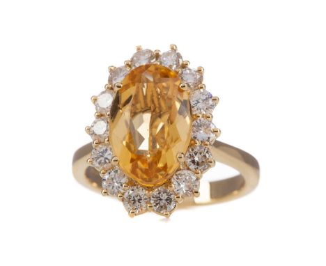 CITRINE AND DIAMOND RING,the oval citrine of approximately 3.00 carats, within a halo of round brilliant cut diamonds totalli