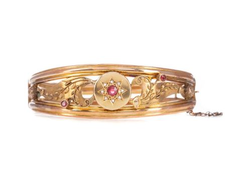 VICTORIAN RED GEM SET AND DIAMOND BANGLE,the central red gem and diamond cluster flanked by scrolling sections and bezel set 