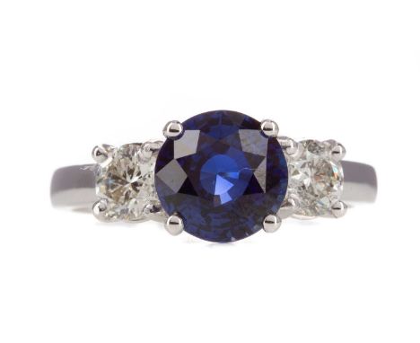 SAPPHIRE AND DIAMOND THREE STONE RING,the round sapphire of approximately 2.65 carats flanked by round brilliant cut diamonds