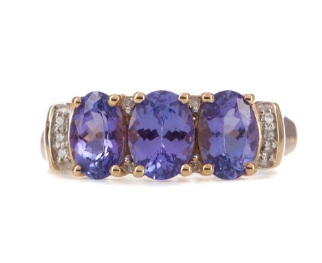 TANZANITE AND DIAMOND RING,set with three oval tanzanites interspaced by round brilliant cut diamonds, in nine carat gold, si