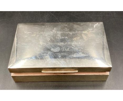 A rectangular silver cigarette box, cedar lined, the lid engraved with inscription Major J H T Reynolds R E M E from the offi