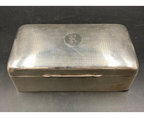 A silver engine turned cigarette box, top engraved with the letters R/K within a Cartouche, indistinct makers mark and hallma