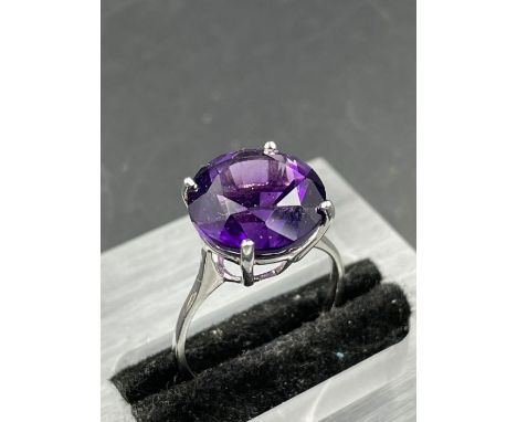 A single stone amethyst ring, round cut amethyst weighing an approximate 6.50ct, fourclaw set, mounted on a ploshed 9ct white