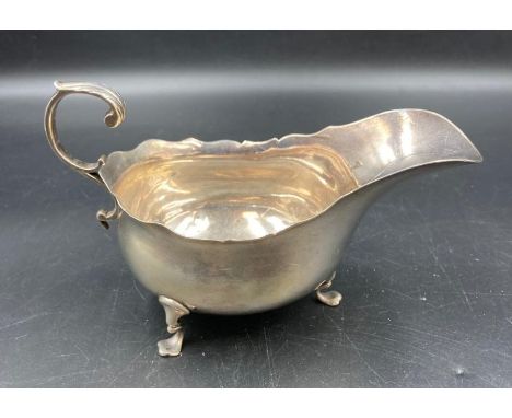 A silver sauce boat on three hoof feet, hallmarked for Chester, dated 1905 by Haseler Brothers