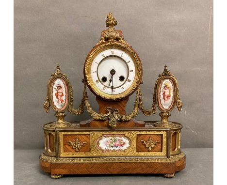 An eight day enamel mantle clock with gilt detail and swags, three hand painted enamel featuring cherubs and flowers. AF 