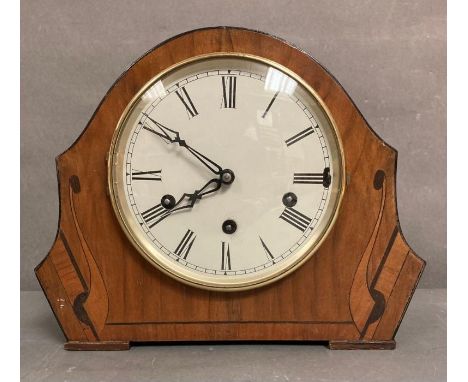 A mahogany cased inlaid eight day mantle clock