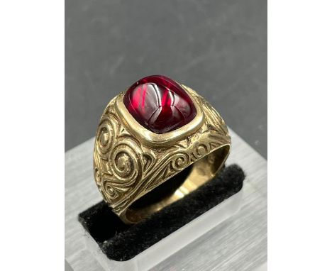 A synthetic ruby signet ring, central cushion shaped, cabochon cut synthetic ruby measuring 11.8 x 9.35mm rubover set with en