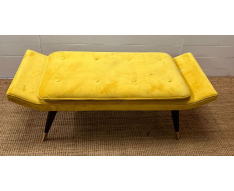 A velvet yellow bench seat on tapering legs (H42cm W127cm D49cm)