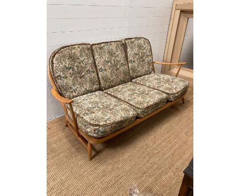 An Ercol sitting room suite consisting of three arm chairs, a foot stool and a three seater sofa (Sofa AF)