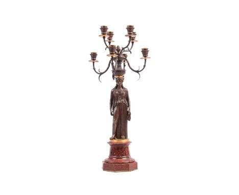 In the manner of Pierre Philippe Thomire, a French Neo-Classical bronze candelabra, with eight candle sconces above a Grecian