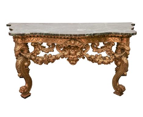 Probably to a design by Henry Flitcroft, a serpentine marble-topped carved wood and gilt gesso console table, probably 18th c