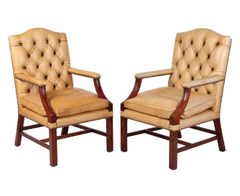 A pair of probably Brights of Nettlebed mahogany "Gainsborough" library armchairs with deep buttoned and close nailed ivory c