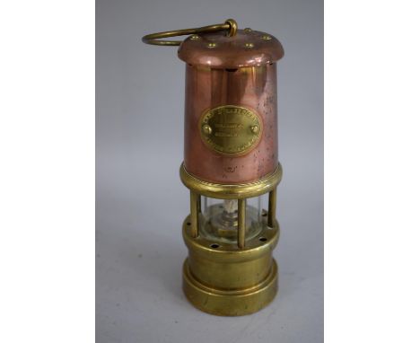 A Miniature Ornamental Brass and Copper Miners Safety Lamp by the Lamp and Lime light Company, 17cm High