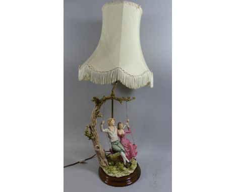 A Figural Table Lamp in the Form of Boy and Girl on Swing, Complete with Shade, 80cm High 