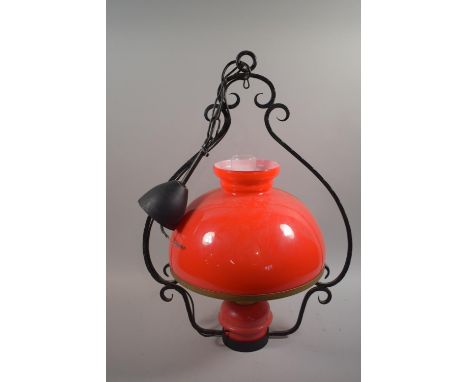 A Ceiling Light Fitting in the form of an Oil Lamp, with Red Glass Shade 