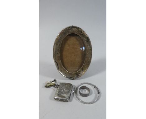 A Small Silver Vesta, Small Silver Child's Bangle and Ring Together with a Silver Oval Photo Frame