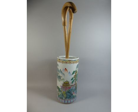 An Oriental Ceramic Stick Stand Containing Two Walking Sticks