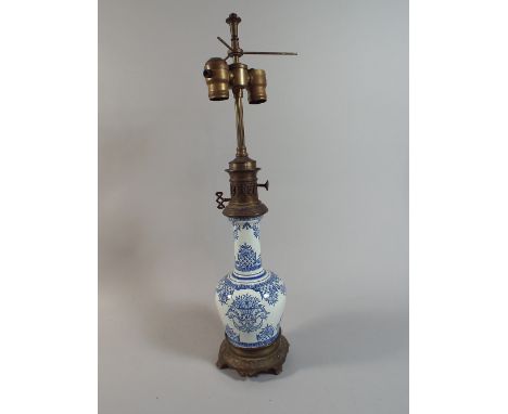 An Early 20th Century French Blue and White Ceramic Table Lamp with Brass Mounts, 61cm high 