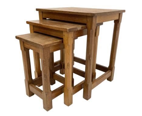 'Mouseman' oak nest of three tables, rectangular adzed tops on octagonal supports joined by pegged stretchers, each table car