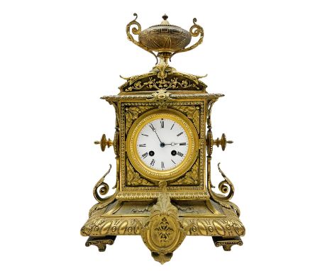 French brass cased mantle clock c1880 with a domed pediment surmounted by a twin handled urn, rectangular case with finials t