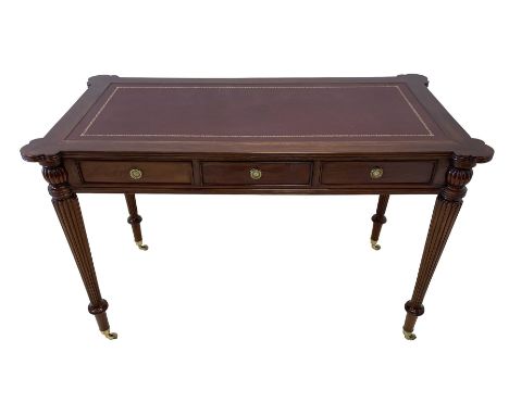 Regency style mahogany writing table, the top with projecting shaped corners and moulded edge with leather inset, fitted with