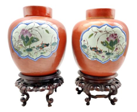 Pair of 19th century Chinese porcelain burnt orange ground ginger jars and covers, each having two reserves enamelled with pa