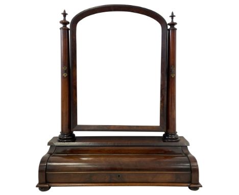 Mid-19th century mahogany toilet mirror, the arched mirror in chamfered slip and supports by two tapered columns with finial,
