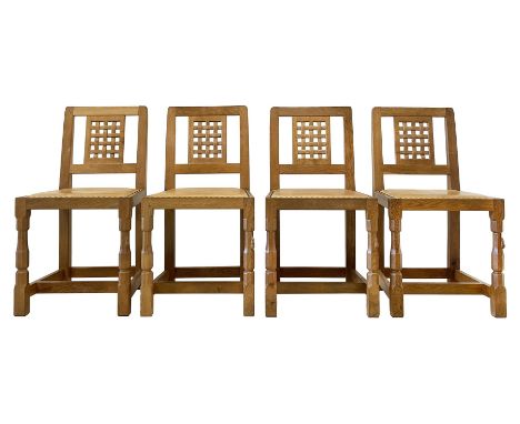 'Mouseman' set four oak dining chairs, lattice carved back, upholstered in tan leather with studded band, carved with mouse s