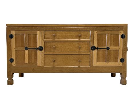 'Mouseman' oak sideboard, fitted with three drawers and two panelled cupboards, adzed top, panelled sides, wrought iron hinge