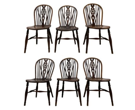 Early 19th century harlequin set of six elm and beech Windsor chairs, hoop and stick back with pierced wheel splat, on dished