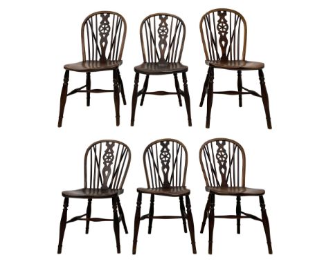 Early 19th century harlequin set of six elm and beech Windsor chairs, hoop and stick back with pierced wheel splat, on dished