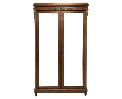 20th century Louis XVI style walnut armoire wardrobe, enclosed by two bevel edged mirror doors, the interior fitted with four