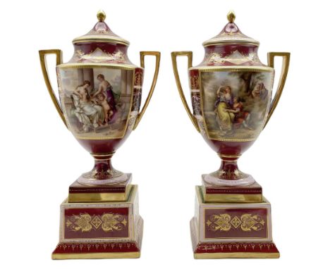 Pair of Vienna style two-handled vases and covers, each reserved with a panel painted by K. Weh with either 'Schmukung der Ve