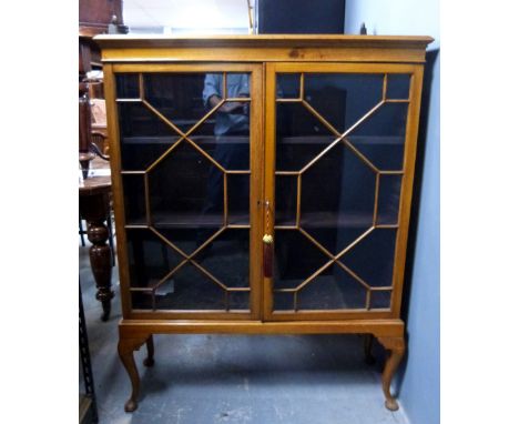 Edwardian light walnut  glazed cabinet on cabriole legs.   
