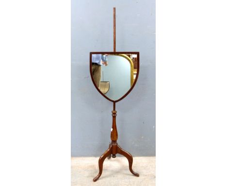 Adjustable shield shaped shaving mirror on stand lacking shelf, and a wall mirror.   