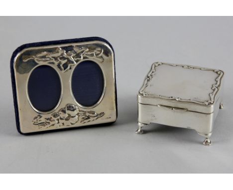 Silver trinket box set on four feet, Birmingham 1910 and a twin fronted silver photo frame .   