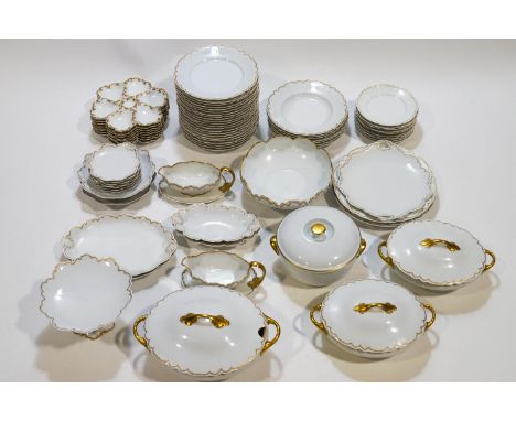 An extensive Limoges dinner service with gilt rims, together with eight Limoges oyster plates, two pairs of similarly decorat